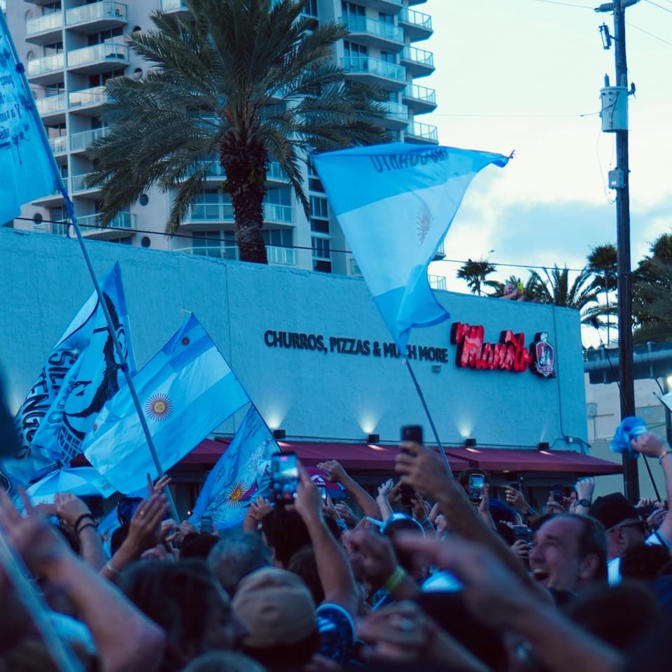 Argentina supporters waving sky-blue and white flags outside Manolo on Collins Avenue.